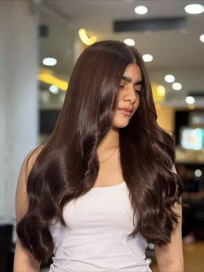 A beautiful, soft chocolate global hair color. This luxurious shade enhances the client's overall look, adding depth, smoothness, and a natural glossy finish.
