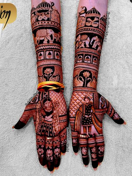Another angle of the portrait mehndi from the previous images. This design features a bride on one palm and a groom on the other, with elephants and lotus motifs on the forearms.