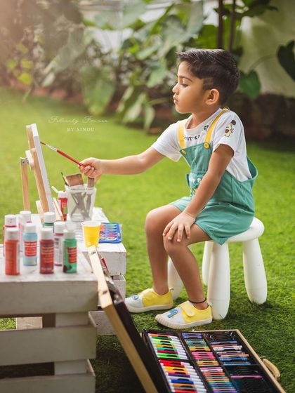 A young artist at work! This outdoor session captured this little boy's love for painting.