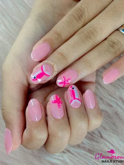 An adorable underwater-themed design with a soft pink base, featuring hand-painted fish and starfish in shades of pink and white.