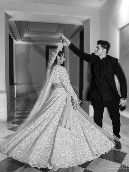 A dance of love. This black and white shot captures the movement and joy of the couple's first dance, frozen in a timeless frame.