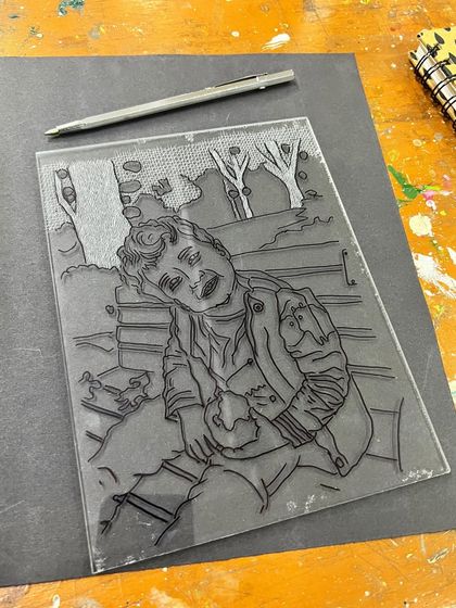 A finished drypoint plate, etched with the portrait of a child. This technique allows for very fine, detailed linework similar to drawing.