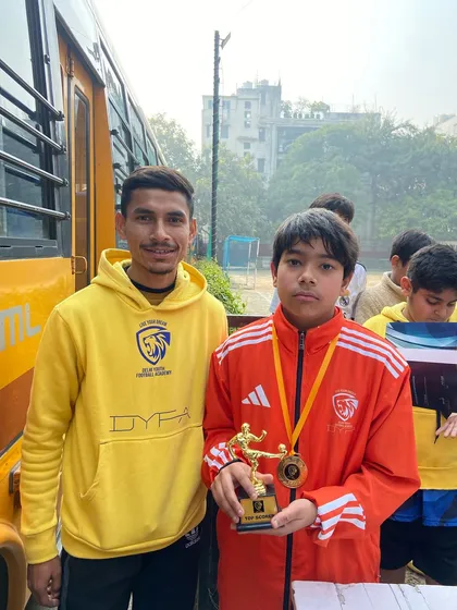 Another one of our players with his well-earned trophy and medal. The smile says it all.