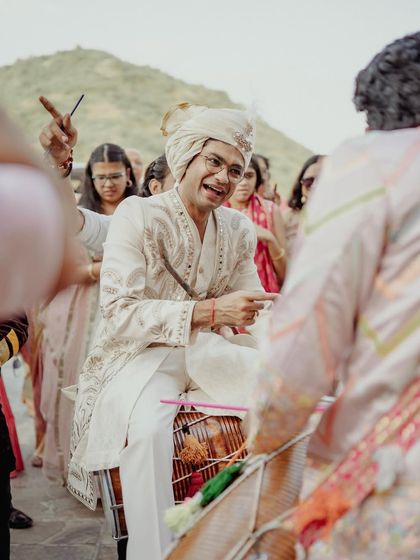 The groom takes a turn on the dhol during his own baraat.