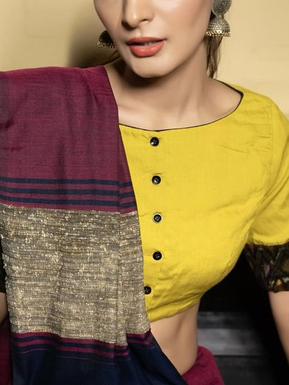 A different angle of the yellow cotton boat neck blouse, paired with a deep maroon saree. The contrast of the bright yellow against the rich maroon is simply stunning.