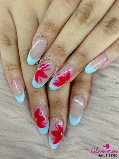 A beautiful contrast of colors. This set features a modern French manicure with soft blue tips, with accent nails showcasing bold, hand-painted red flowers. It's a fresh and artistic take on a classic style.