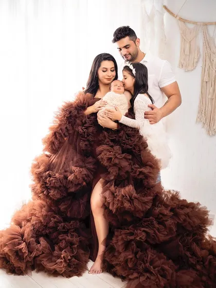 A stunning portrait of this new family of four, wrapped in a beautiful tulle gown. This shows how we can combine a glamorous maternity dress with a newborn session.
