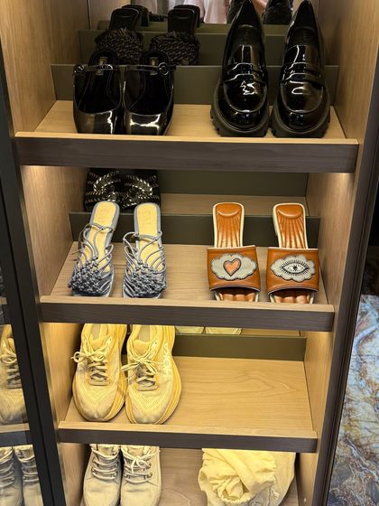 A selection of stylish footwear, from sneakers to sandals, neatly arranged on open shelves. We always organize pairs together, making it quick and easy to grab what you need.