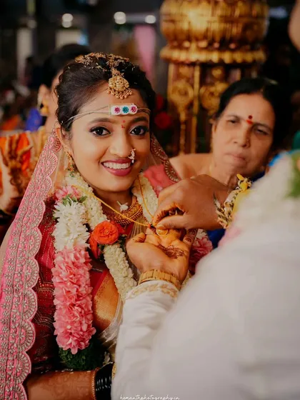 The tying of the Mangalsutra is one of the most sacred moments of the wedding. I capture a close-up of the bride's happy expression as the groom performs this ritual.