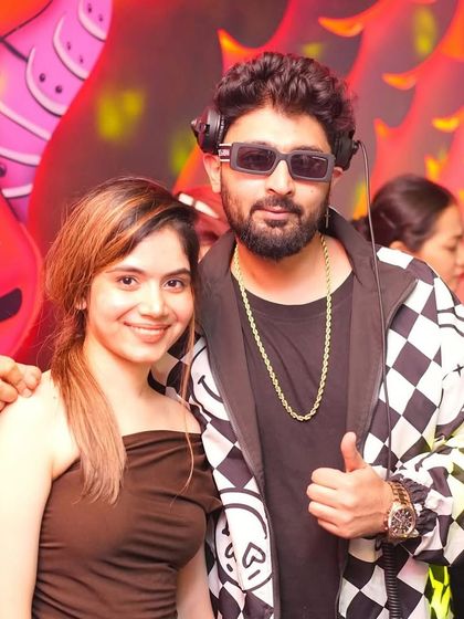 Posing with a fan during my set. I love connecting with the people who enjoy my music.