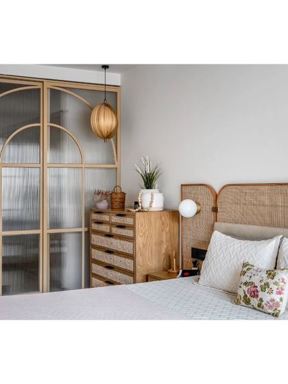 Another view of the master bedroom, highlighting the custom fluted glass wardrobe and the natural textures that make the space feel so calming.