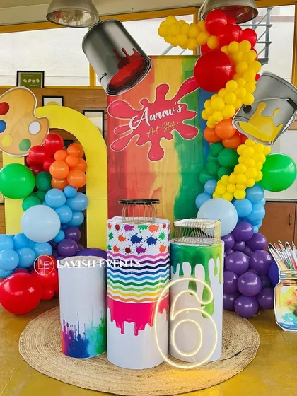 Another angle of the art studio theme, showcasing the creative props like paint palettes, brushes, and overflowing paint cans.
