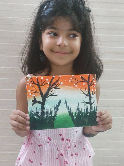 This young artist is so happy with the patriotic landscape she painted. Her smile and her artwork both shine brightly.
