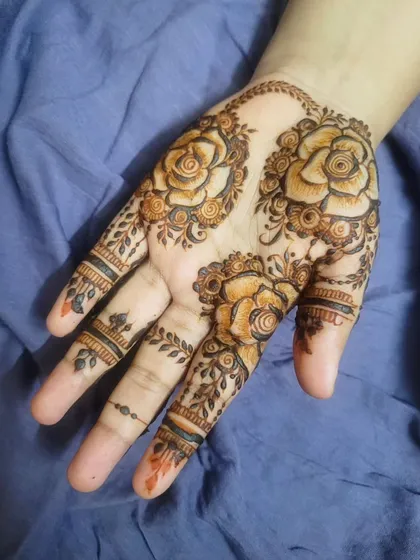 A beautiful Eid design featuring three shaded roses on the palm, surrounded by delicate leafy vines.