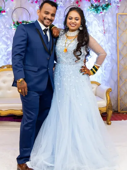 A lovely photo of the couple at their reception. The bride is wearing a modern gown but has kept a touch of tradition with her green bangles. Her makeup is fresh and elegant.