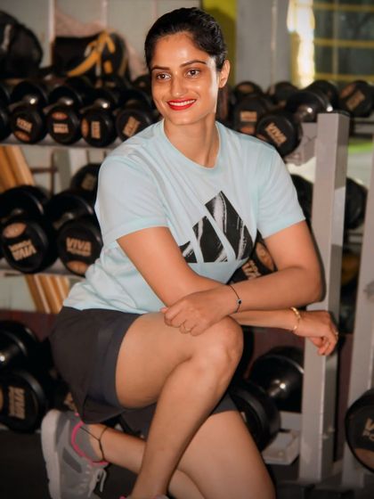 Confidence is built through consistency. Taking a moment to rest between sets, surrounded by the tools of the trade. The dumbbell rack is where strength is forged.