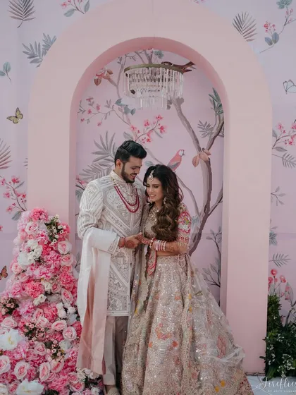 A beautiful portrait of Yasha and Rahil at their blush-themed wedding. The custom-printed floral wallpaper and cascading pink flowers created a romantic and picturesque photo opportunity.