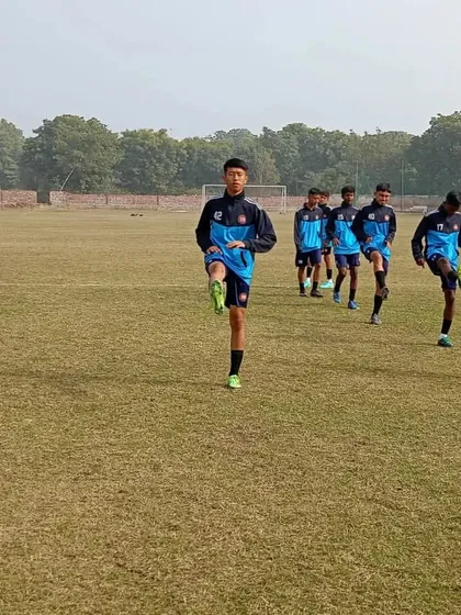 Players engaged in a dynamic warm-up routine, preparing their bodies for an intense training session.