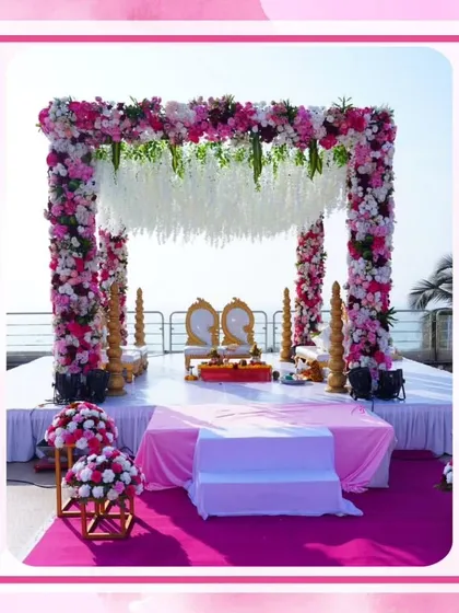This beautiful pink floral mandap was set up for a beachside wedding. The open design allows for stunning views of the sea, while the dense flowers create a romantic and celebratory frame for the couple.