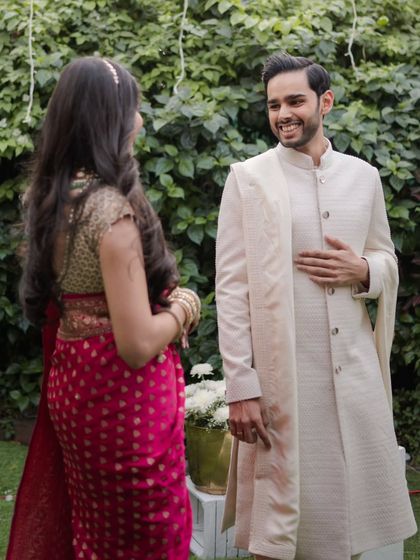The groom's delighted reaction upon seeing his bride for the first time, a moment of pure, unfiltered joy.