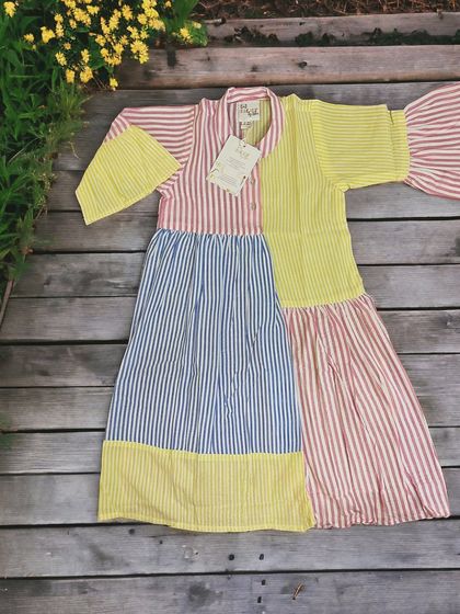 Sweet as candy! This adorable multi-color frock with playful stripes and mismatched sleeves is perfect for your unique little one. It's sure to brighten up her day.