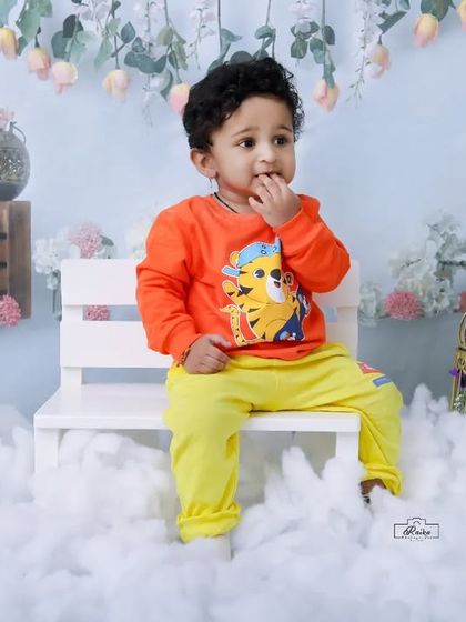 This little boy is looking thoughtful while sitting on a bench in our winter wonderland. The setup includes cute teddy bears and other props to make it fun.