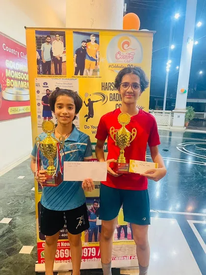 Double the effort, double the reward. Two of our dedicated young players showcasing their trophies after a successful tournament run. We foster a supportive environment where students motivate each other to succeed.