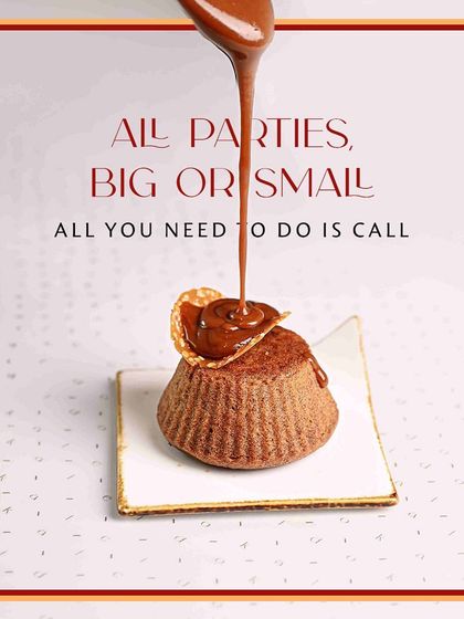 All parties, big or small, deserve a sweet finish. This image shows a decadent chocolate lava cake being drizzled with a thick chocolate sauce, a perfect indulgence for any celebration.