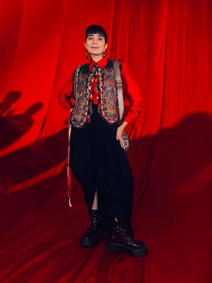 The full look for couture week, pairing a traditional embroidered vest with modern dhoti pants and combat boots.