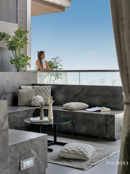 Another view of the magnificent marble deck, looking out towards the horizon. The mix of knit pillows and sculptural objects creates a space that is both stylish and deeply relaxing.