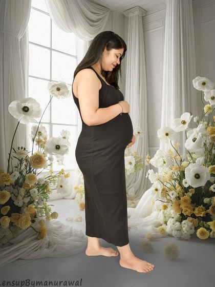 A serene portrait in a simple black dress, set against a dreamy backdrop of white and yellow paper flowers in my studio. This shows how we can use props to create a soft, artistic, and personalized setting.