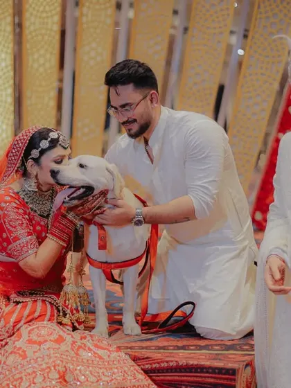 Even the furry family members get to be part of the celebration! The bride sharing a sweet moment with her dog on her wedding day is a heartwarming and unforgettable memory.