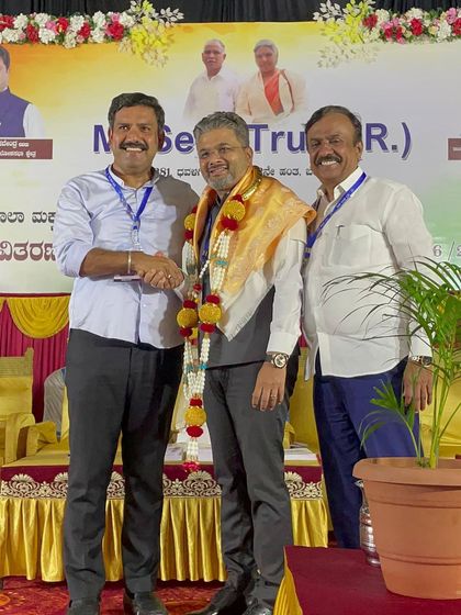 Being felicitated with a shawl and garland by the event organizers. I accept this honor on behalf of all our volunteers.