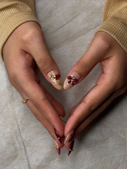 A heart shape made with the hands shows off the beautiful, detailed nail art from every angle.