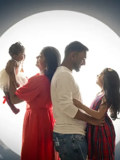 A creative family silhouette against a moon and clouds backdrop. This artistic composition is a unique way to capture your family's bond.