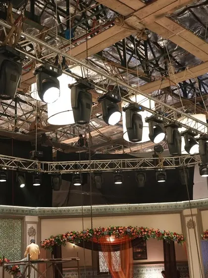 The overhead lighting grid for the 'Deva' set, showing a mix of intelligent lights and practicals like lanterns and chandeliers.