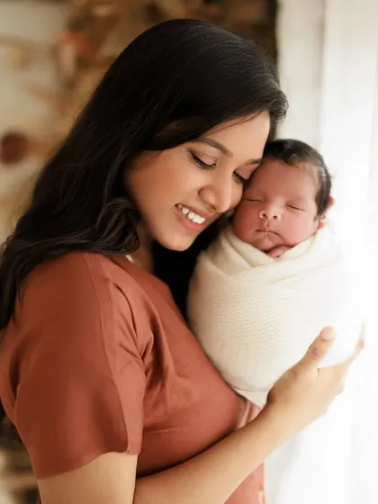 Unconditional love in its purest form. A mother's smile says it all as she cuddles her peacefully sleeping newborn. A truly magical moment.