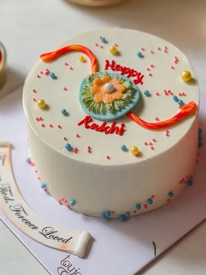 A simple and sweet mini cake for Rakshabandhan. This cake is decorated with an edible rakhi made of buttercream, making it a thoughtful and delicious gift for your sibling.