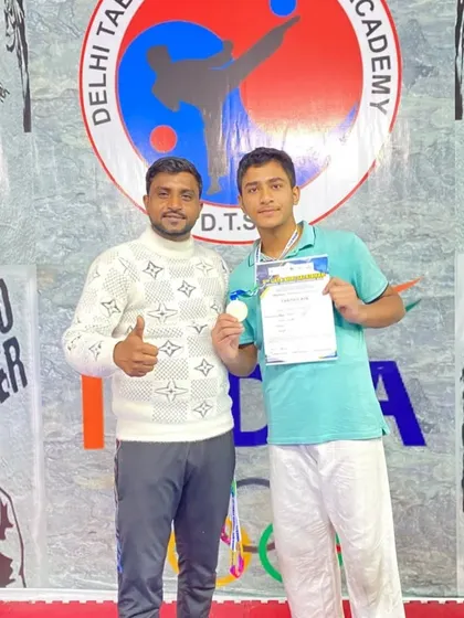 A proud moment with one of my senior students, who won a silver medal and received his certificate.
