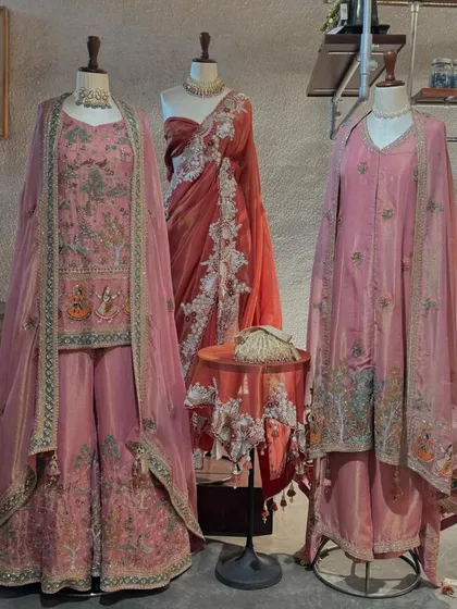 A full display of Jaya Rathore's collection, featuring intricately embroidered suits and a stunning red saree, all telling a story of heritage and craftsmanship.