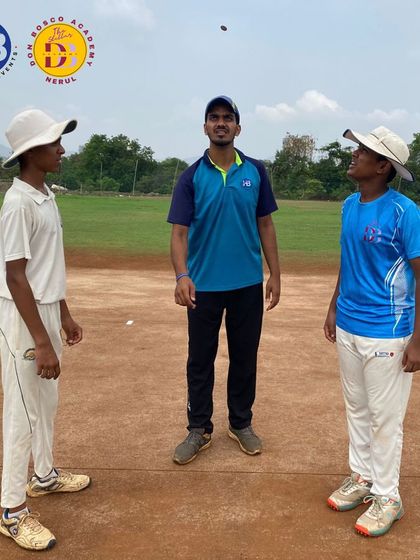 A coach and two young players during a coin toss before a practice match. This moment captures the sportsmanship and formal procedures of the game that we teach our athletes.