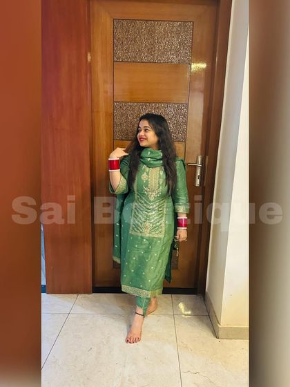 A client looking elegant in a green silk suit. The simplicity of the design highlights the rich fabric and color.