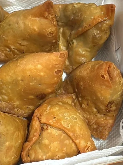 Freshly fried and ready to serve. These crispy, golden-brown samosas are a classic party snack that we make for events and bulk orders. They are perfect with a cup of chai.