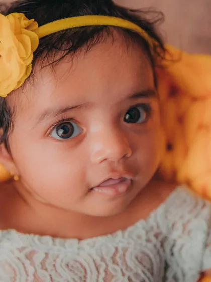Those wide-eyed, curious expressions are so precious. This simple and sweet 3-month milestone photo highlights the delicate features and pure innocence of this stage, using soft textures and natural light.