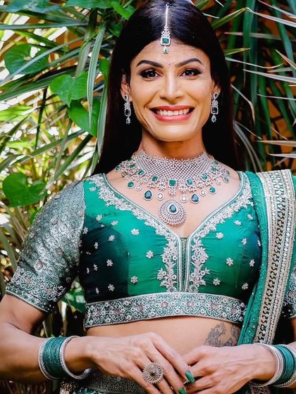 A beautiful smile from a model adorned in our sparkling green and silver-toned jewellery.