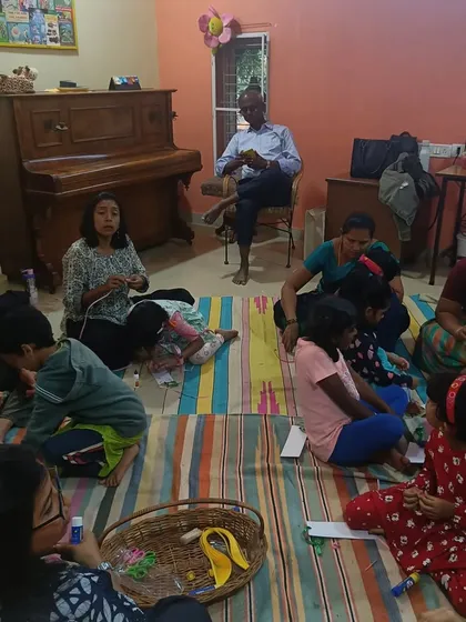 A wide view of our craft session, showing a full room of families engaged in making things together. The atmosphere is relaxed, creative, and communal.