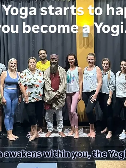 A group photo with students after a class, with the words "When Yoga starts to happen, you become a Yogi." This captures the transformative power of a consistent practice.