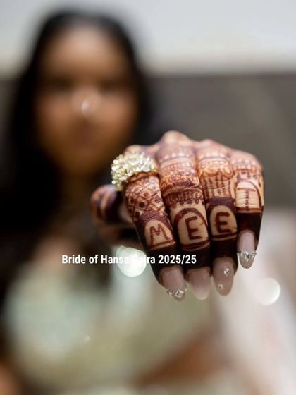 A unique back-of-hand design featuring the bride's name spelled out on her fingers. This is a fun and personal way to add a modern twist to your mehendi.