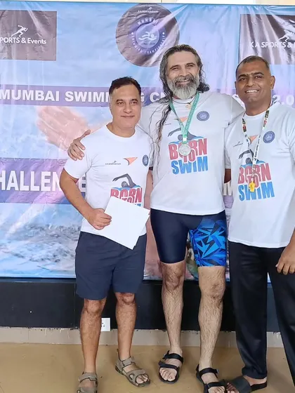 Sharing a moment of success with a swimmer. My coaching philosophy is about building people, not just athletes. The bond we form through training is as important as the medals we win.
