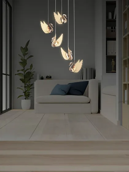 The rose gold swan chandelier is a delicate and artistic piece, perfect for creating a focal point in a living room or a quiet corner.